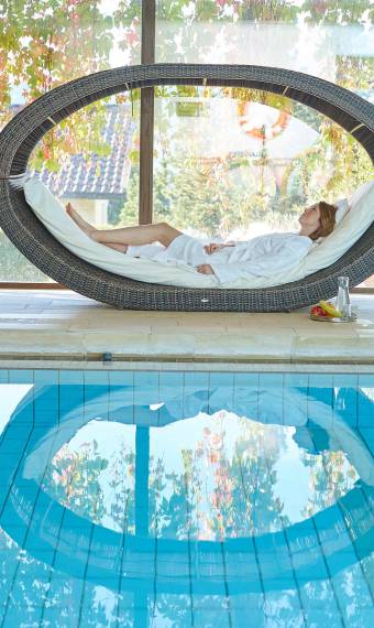 woman relaxing at the pool wellness hotel 