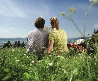 couple in meadow with hiking plan